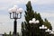 Row with white round shades on street lights in the street