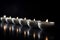 Row of White Tea Candles Perfectly Aligned on a Smooth Surface. Generative AI