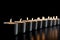 Row of White Tea Candles Perfectly Aligned on a Smooth Surface. Generative AI