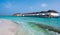 Row of white tropical houses above the sea