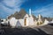 A row of whote trulli house in Alberobello, Italy