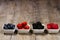 Row of wild berries in bowls