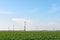 A row of wind turbines in an agricutural field