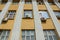 Row window on a brown wall of a building with air conditioning