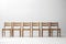 a row of wooden chairs on a pristine white background