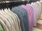 Row of working shirt hanging orderly on cloth shop