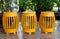 A row of yellow cylinder shape stools