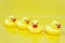 A row of yellow duck toy on yellow background and one of the ducks facing in a different direction, Undisciplined, Think outside