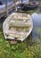 Rowboat in front of a line of colorful boathouses