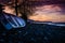 Rowboat Left On The Pebble Shore Sunset