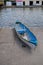 Rowboat with paddle docked in Belize City Belize near The Swing Bridge with random fork on ground