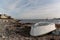 Rowboat on the shoreline of a harbor