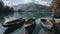 Rowboats moored in lake against mountains range