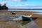 Rowboats on the sandy shore of a harbor