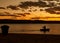 Rowing alone in sunset