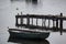 Rowing boat above calm water, reflection in water