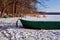 Rowing boat in the snow on a frozen lake