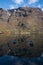 Rowing boats on mountain reflected in water