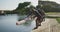 Rowing team of four senior caucasian men and women lowering boat into river