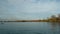 Rowing team on water. Landscape of Lake Geneva, tree, sky and clouds. Real time.