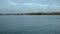 Rowing team on water. Landscape of Lake Geneva, tree, sky and clouds. Time lapse.