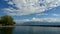 Rowing team on water. Landscape of Lake Geneva, tree, sky and clouds. Time lapse.