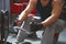 Rowing young man in gym training hands close up