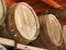 Rows of aged wooden wine barrels