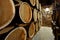 Rows of alcoholic barrels are kept in stock. Distillery. Cognac, whiskey, wine, brandy. Alcohol in barrels, alcohol