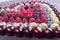 Rows of assorted fruits and berries: sweet cherry, bluberries, r