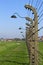 Rows of barbed wire with lanterns across Auschwitz perimeter