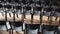 Rows of black chairs in the auditorium for presentations, seminars and meetings.