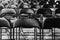 rows of black empty chairs in entertainment hall