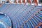 Rows of blue grandstand for fans at football stadium.