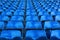 Rows of blue old steel seats in football stadium.