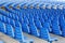 Rows of blue plastic chairs on a metal base  in rows around the circle in the hall for business presentations