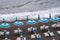 Rows of blue and white parasols and sunbeds on the beach at Atrani on the Amalfi Coast, Italy.