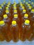 Rows of bottles of sunflower or olive oil for sale. Fresh natural farm products for delivery to a supermarket, local market or fai