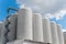 Rows of brewing tanks against the sky. Industrial beer production.