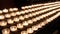 Rows of burning lit candles / tealights in Catholic Christian Church