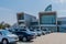 Rows of cars parked in front of Jeongok Marina Clubhouse on sunny morning