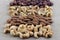 Rows of cashew nuts, almonds, walnuts and hazelnuts on a burlap fabric. Selective focus on cashews.