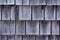 Rows of cedar shingles shrunk and faded gray with age