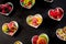 Rows of ceramic heart shaped bowls with candies