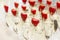 Rows of champagne glasses decorated with strawberries at the buffet table. Close-up