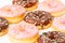 Rows Of Chocolate And Pink Donuts With Sprinkles