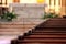 Rows of church benches. Sunlight reflection on polished wooden pews. Selective focus