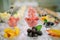 Rows of cocktail glasses with fresh summer fruits and berries