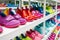 rows of colorful childrens shoes on white display shelves