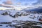 Rows of colorful Inuit houses hiding in the snow and rocks with